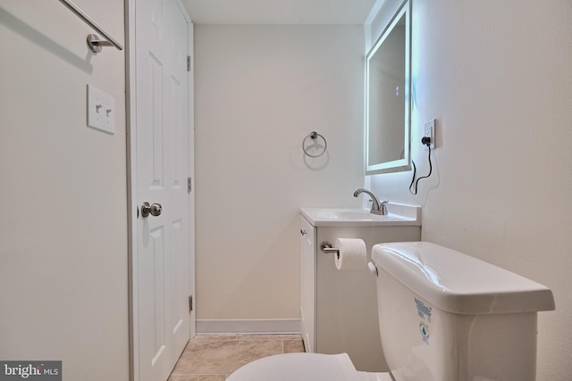 bathroom with vanity, tile patterned floors, and toilet