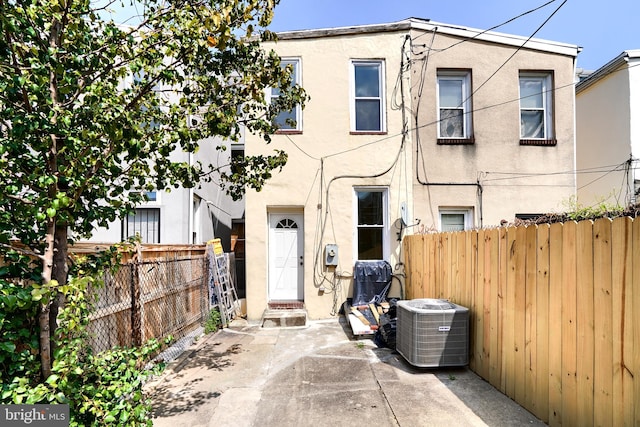 view of front of house with cooling unit and a patio area