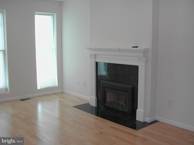 unfurnished living room featuring wood-type flooring