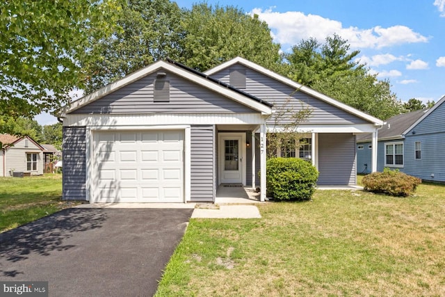 view of front of house with a garage and a front lawn