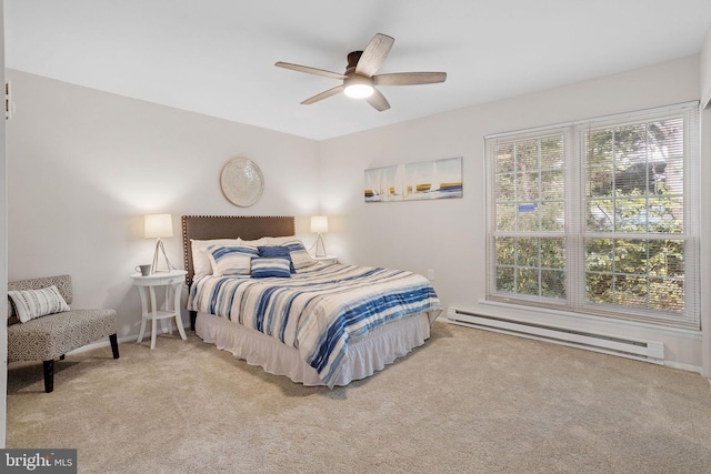 carpeted bedroom with baseboard heating and ceiling fan