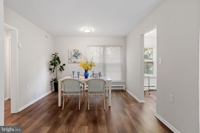 dining area with baseboard heating and dark wood-type flooring