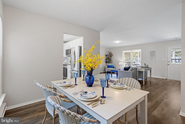 dining room with dark hardwood / wood-style flooring