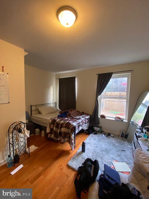 bedroom with wood-type flooring