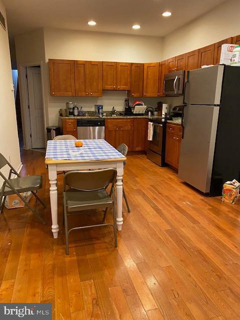 kitchen featuring stainless steel appliances, recessed lighting, and light wood-style floors