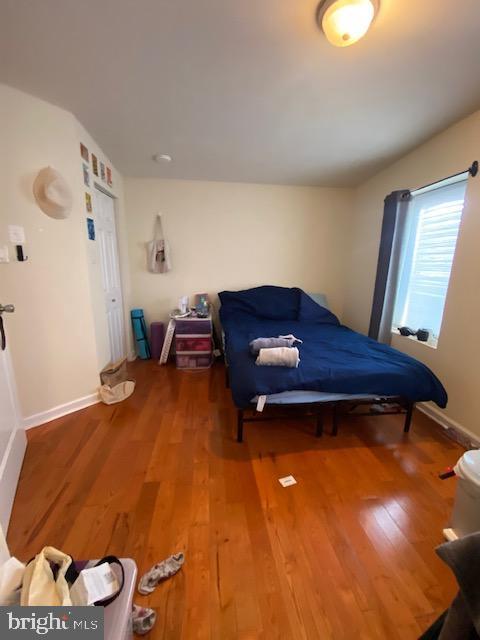 bedroom featuring wood finished floors and baseboards