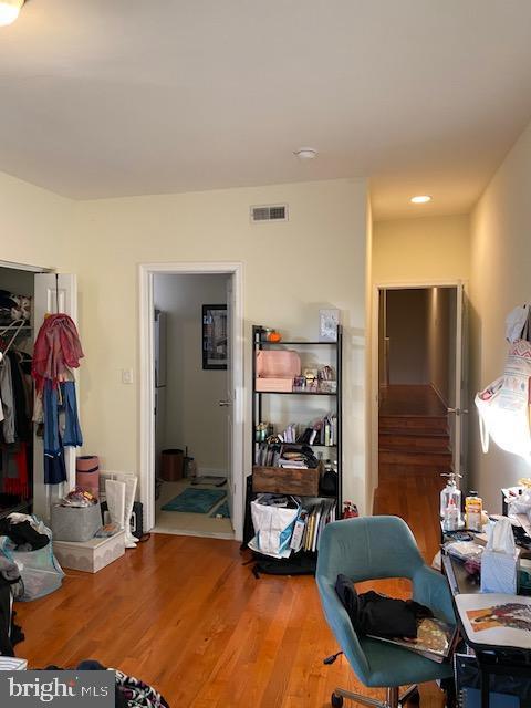 interior space featuring a closet, visible vents, and wood finished floors