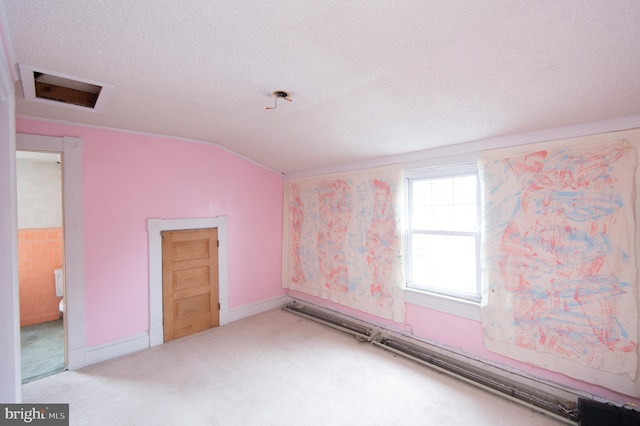 empty room featuring light carpet, a textured ceiling, and vaulted ceiling