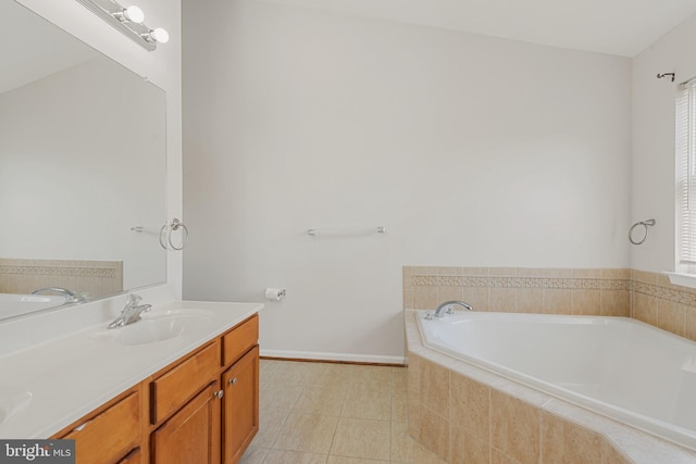 bathroom featuring vanity, tile patterned flooring, and a relaxing tiled tub