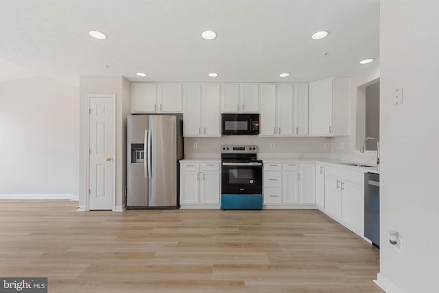 kitchen featuring white cabinets, appliances with stainless steel finishes, sink, and light hardwood / wood-style floors