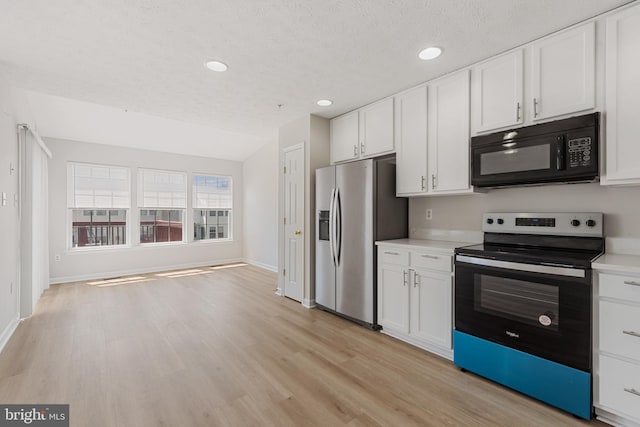 kitchen featuring white cabinets, stainless steel appliances, and light wood-type flooring