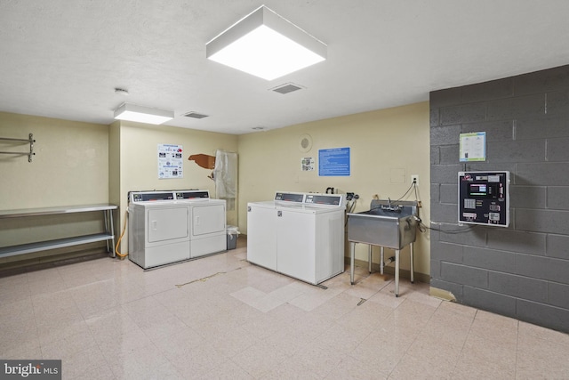 laundry room featuring independent washer and dryer and sink