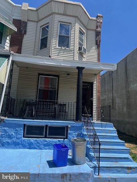 view of front of house with a porch and cooling unit