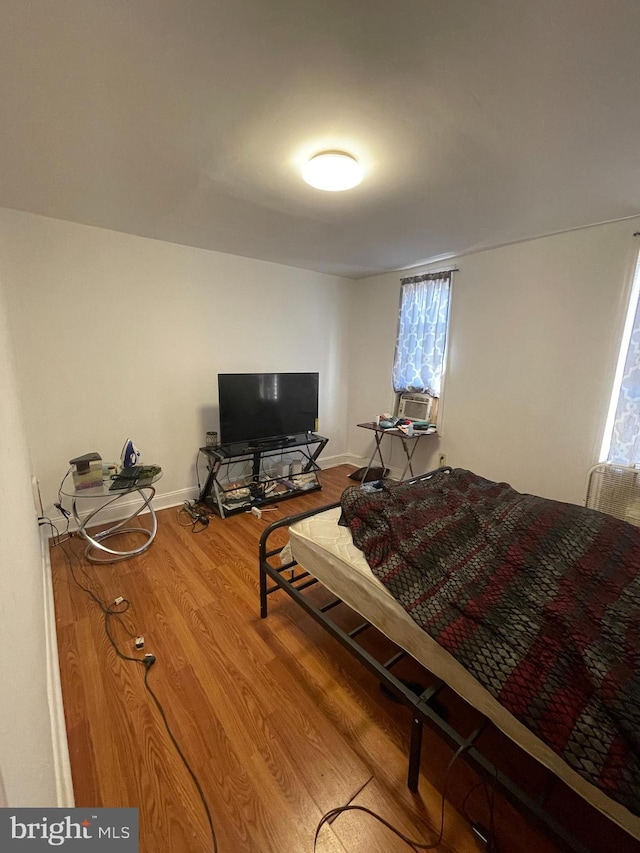 bedroom featuring cooling unit and wood-type flooring