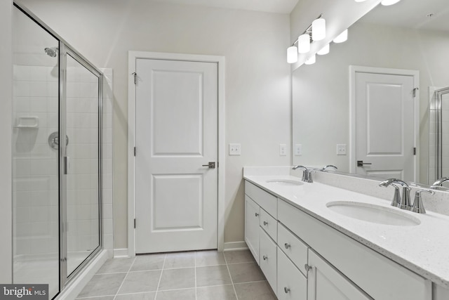 bathroom with tile patterned floors, vanity, and a shower with shower door