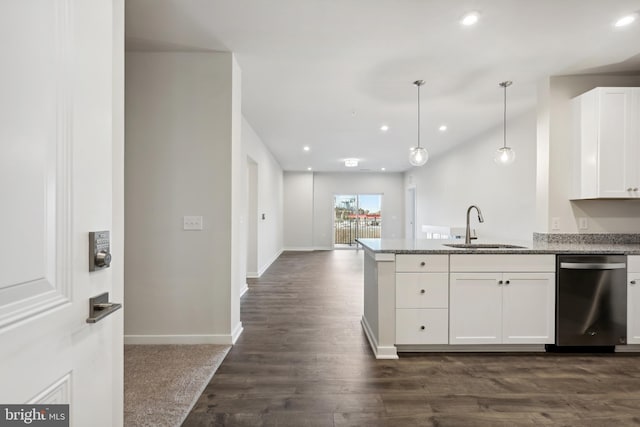 kitchen featuring dishwasher, sink, light stone counters, pendant lighting, and white cabinets