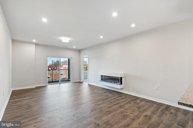 unfurnished living room featuring dark hardwood / wood-style flooring