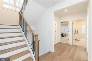 staircase with hardwood / wood-style flooring