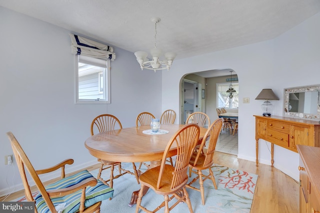 dining room with an inviting chandelier and light wood-type flooring