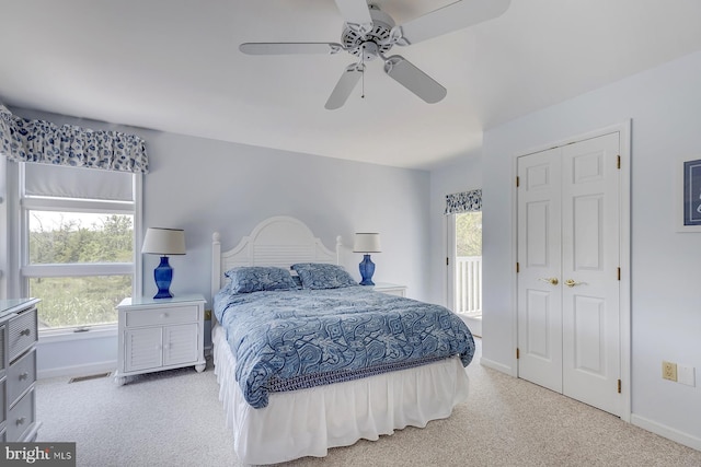 bedroom with light colored carpet, a closet, and ceiling fan