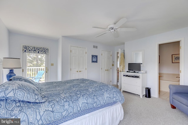 bedroom with ceiling fan, connected bathroom, access to exterior, and light carpet