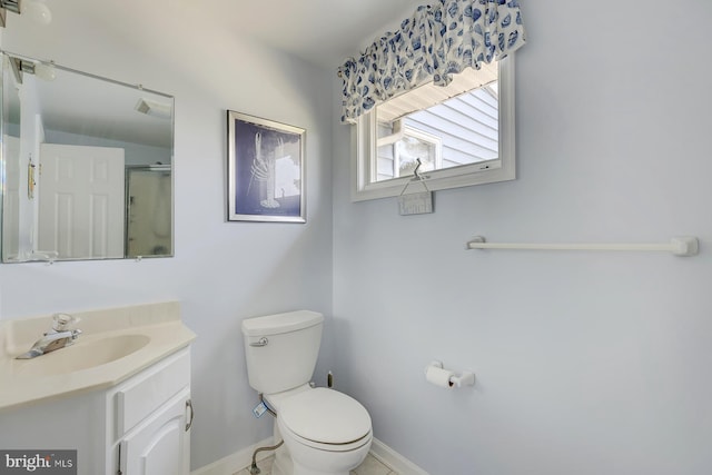 bathroom with vanity, toilet, and an enclosed shower