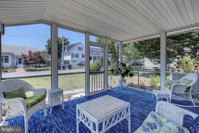 sunroom featuring vaulted ceiling