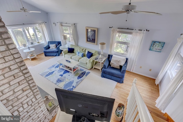 living room with vaulted ceiling, ceiling fan, and light hardwood / wood-style floors