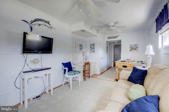 living room with ceiling fan and carpet