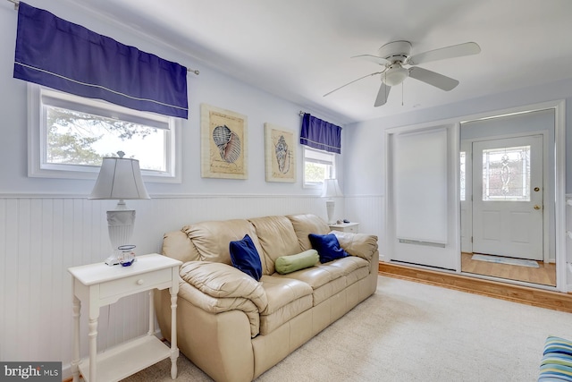 living room featuring ceiling fan, light hardwood / wood-style flooring, and a wealth of natural light