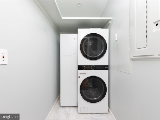 washroom with stacked washer / drying machine