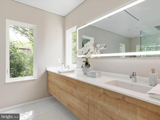 bathroom with plenty of natural light, tile patterned floors, an enclosed shower, and vanity