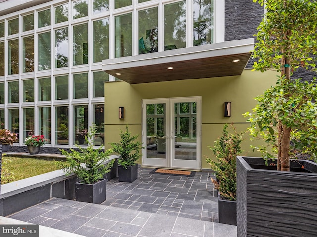 entrance to property featuring a patio area and french doors