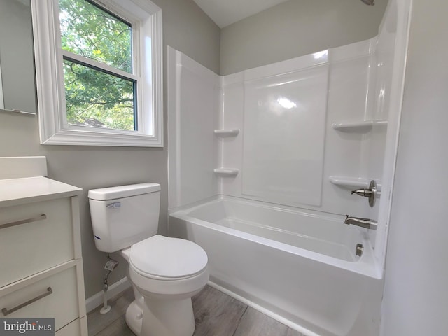 full bathroom featuring vanity, bathing tub / shower combination, toilet, and hardwood / wood-style flooring