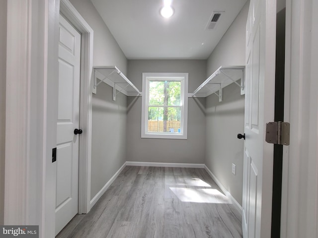 spacious closet featuring light hardwood / wood-style flooring