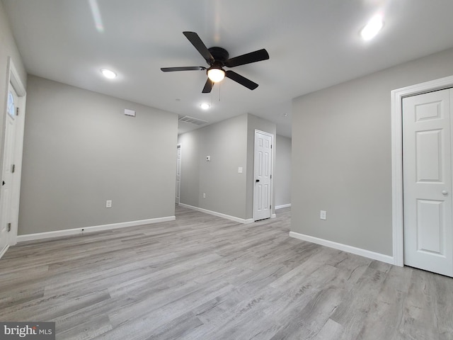 unfurnished room featuring a ceiling fan, light wood-type flooring, visible vents, and baseboards