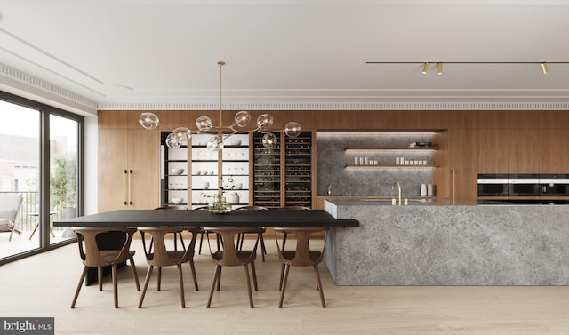 bar featuring wooden walls, sink, light hardwood / wood-style floors, and rail lighting