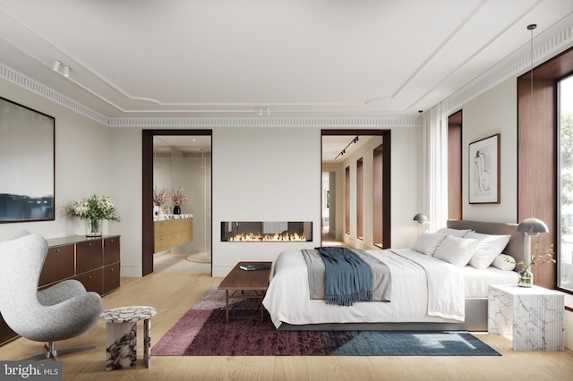 bedroom featuring ensuite bathroom and light wood-type flooring