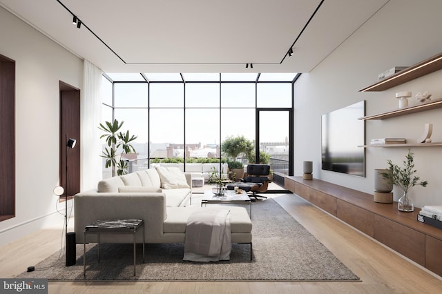 living room with track lighting, floor to ceiling windows, and light hardwood / wood-style floors