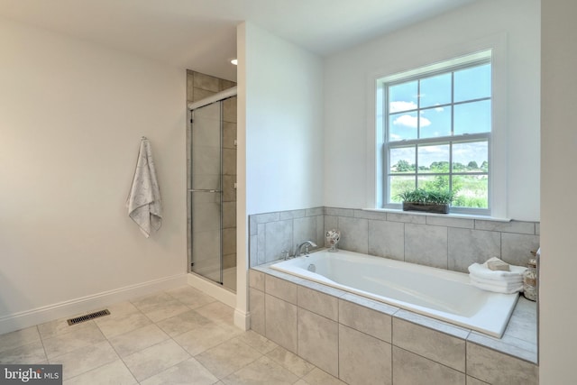 bathroom featuring independent shower and bath, tile patterned flooring, and plenty of natural light