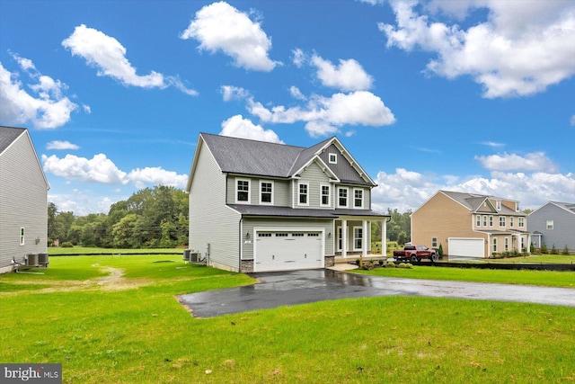 view of front facade featuring a garage, a front lawn, and central AC