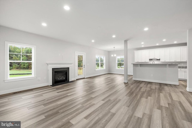 unfurnished living room featuring light hardwood / wood-style flooring