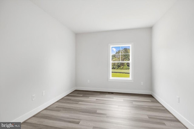 spare room featuring light hardwood / wood-style floors