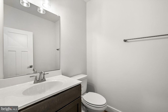 bathroom with toilet and vanity