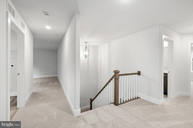 hall featuring light colored carpet