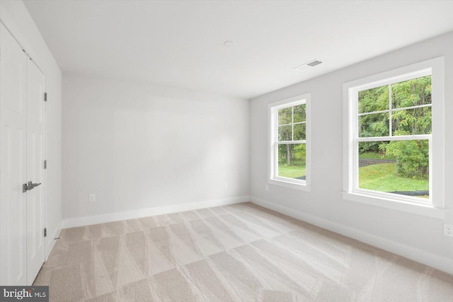 unfurnished room with light colored carpet