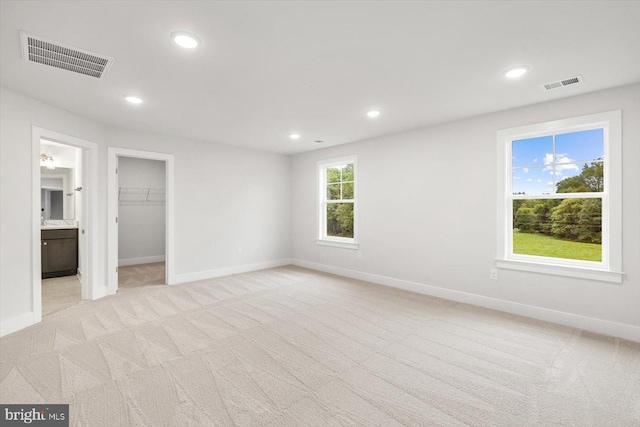 spare room with light colored carpet