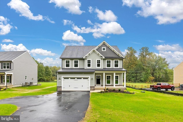 craftsman house featuring a front lawn, a garage, and a porch