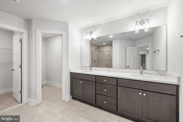 bathroom with toilet, vanity, and walk in shower