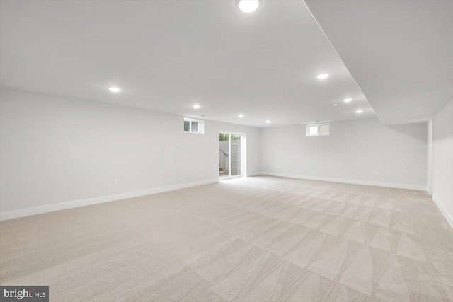 basement featuring light carpet